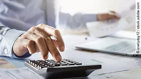 accountant working on desk using calculator for calculate finance report in office accountant working on desk using calculator for calculate finance report in office